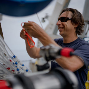 Co-principal investigator Brennan T. Phillips prepares the RAD2 sampling system before ROV SuBastian’s final dive of the “Designing the Future 2” cruise, aboard R/V Falkor on Friday, Aug. 20, 2021. (Jovelle Tamayo / SOI)